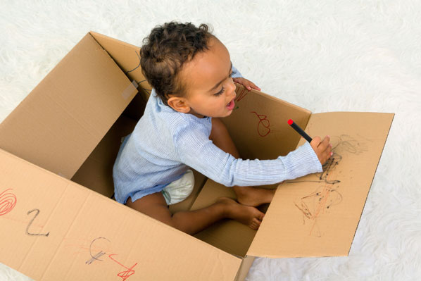 Child in cardboard box